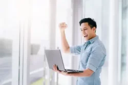 a man happy seeing digital marketing result on his laptop